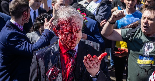 What do Russia and Poland say about the Russian ambassador’s face being splashed with red paint?